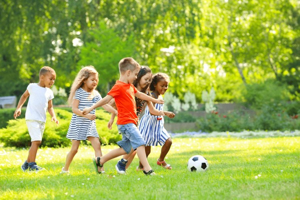 Kids playing soccer together